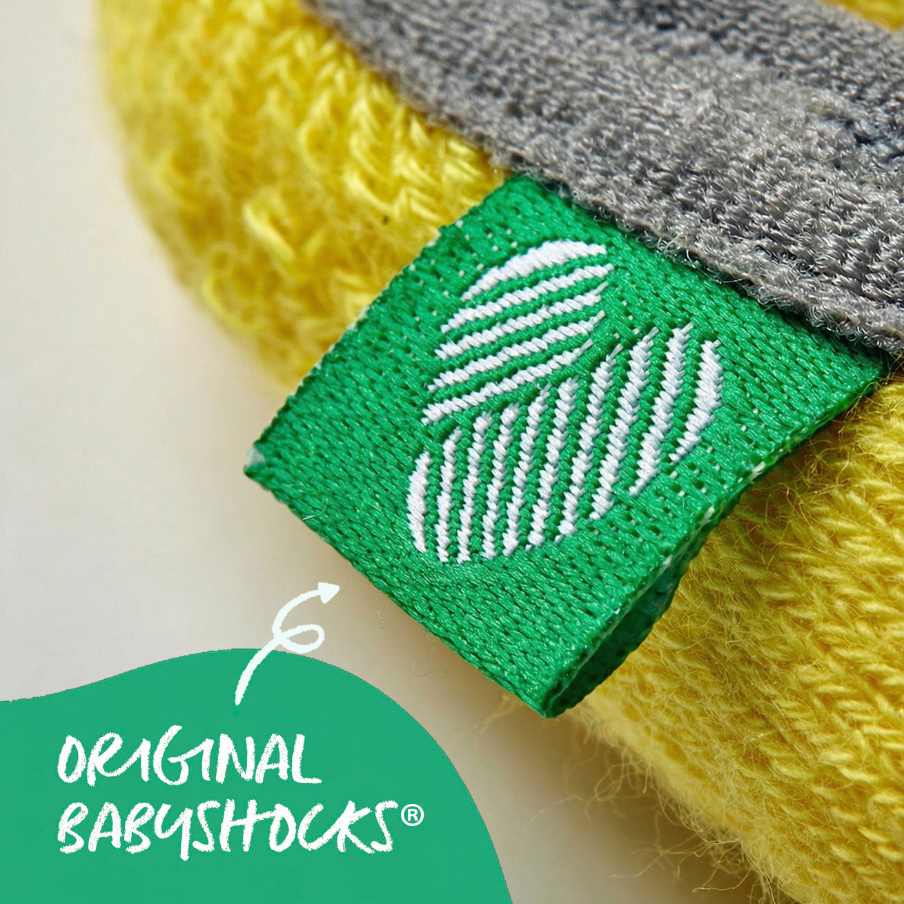 Close-up of BabyShocks logo tag on baby non-slip sock